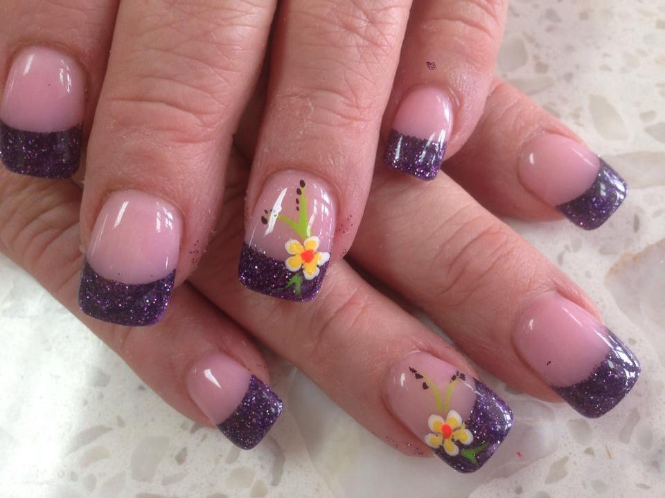 Orange manicure with silver glitter floral accents